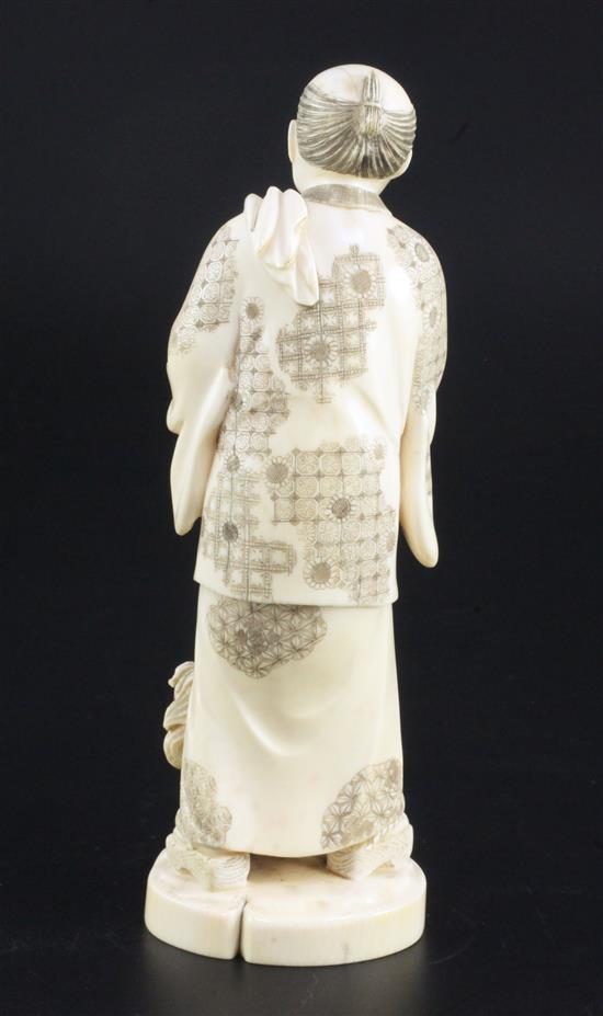 A Japanese ivory okimono of a farmer and a dog, early 20th century, 18.5cm